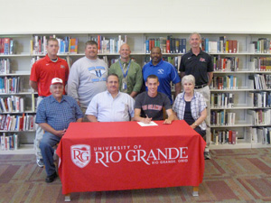 Gallia Academy's Tim Warner poses with family and coaches after signing to continue his career at Rio Grande